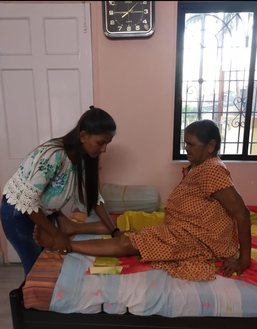 Nurse sharing a warm conversation with an elderly person at home